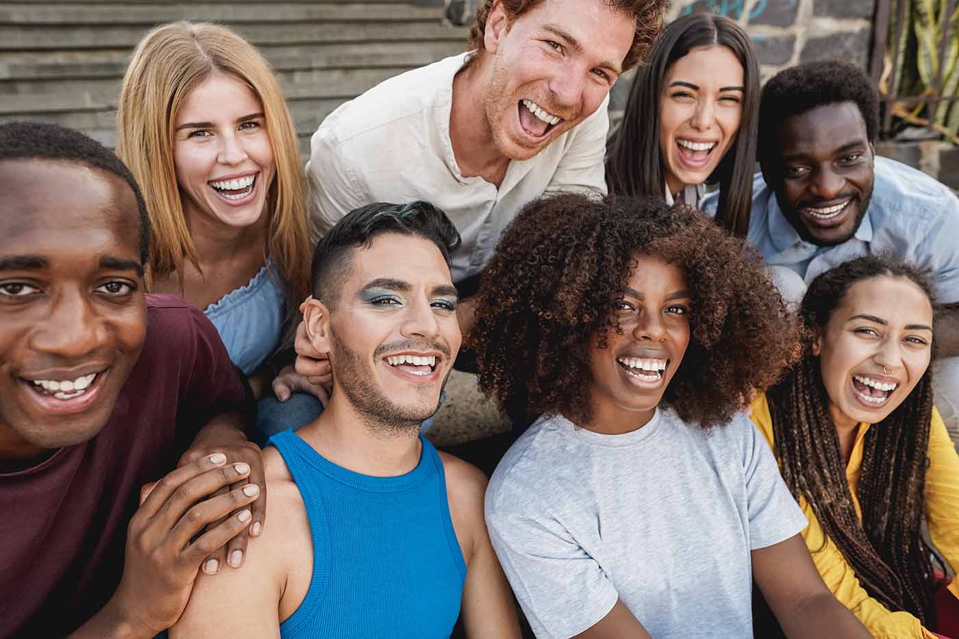People Smiling For Photo On a Bench