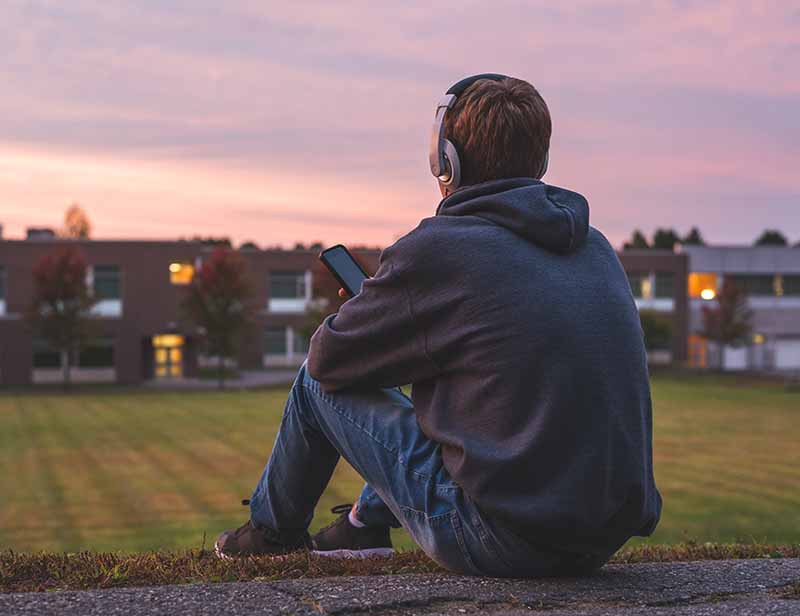 Teenager Sitting By Himself in need of trauma treatment