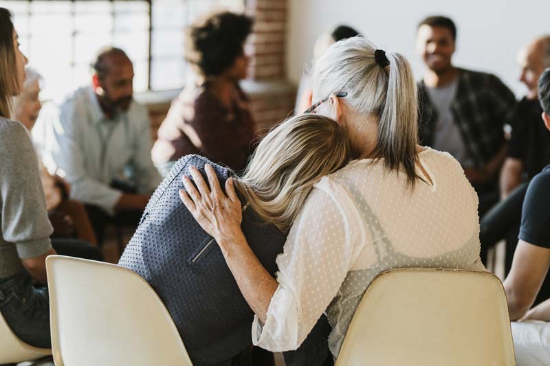Woman Comforting Employee
