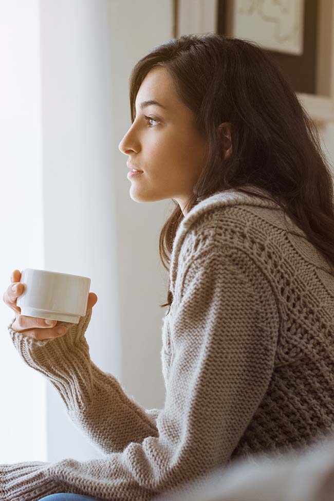 Woman staring out window