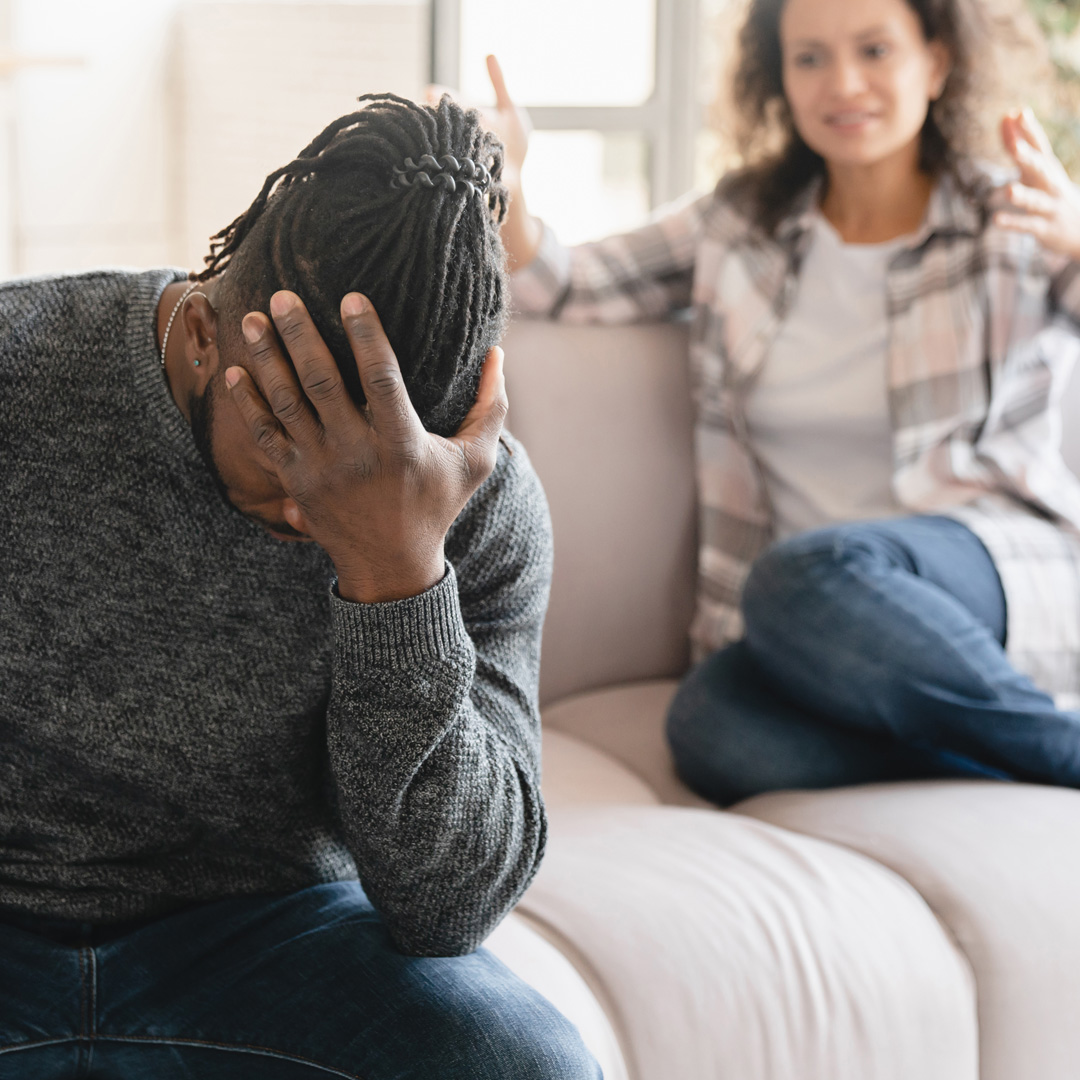 Two People Arguing While Sitting on Sofa